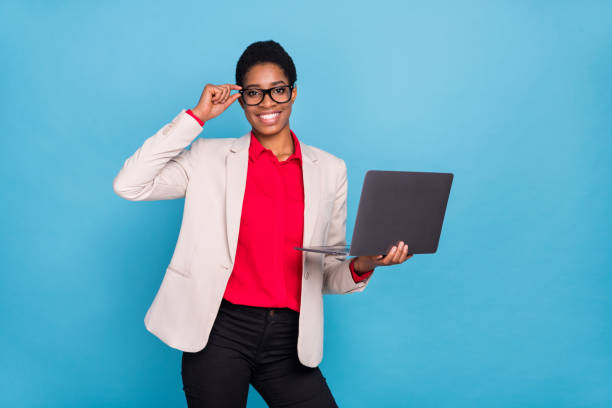 istock Portrait of attractive cheerful specialist using laptop web site analysis touching specs isolated over bright blue color background 2182136841