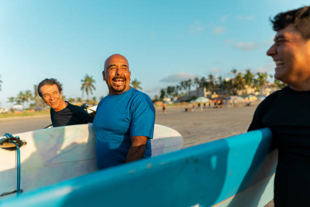 istock Surfer friends talking on the beach 2182137033