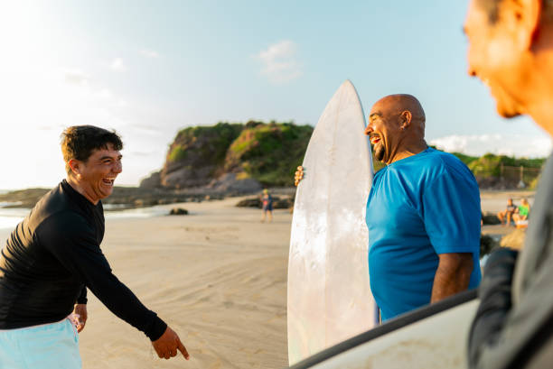 istock Surfer friends talking on the beach 2182137035
