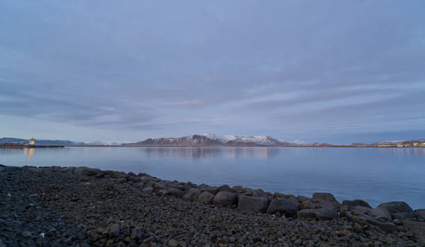 istock Calm ocean reflecting snowy mountains at blue hour in iceland 2182138484