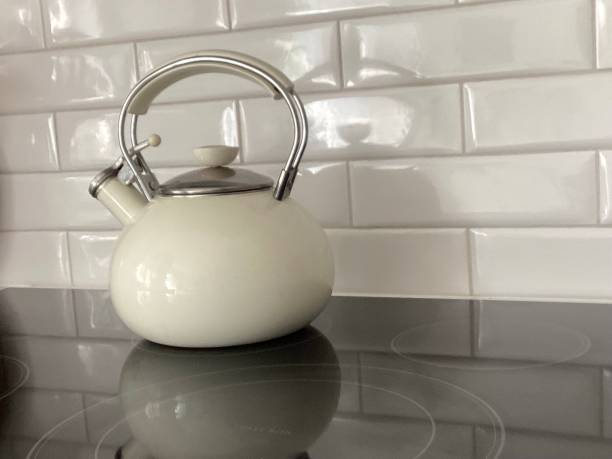 istock Modern kitchen with white subway tile backsplash, induction cooktop, and utensils holder 2182141413
