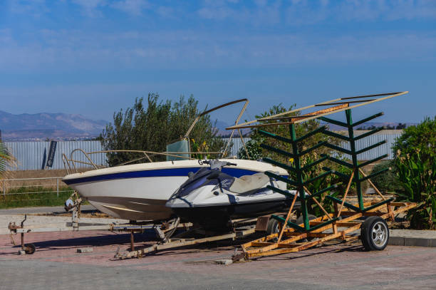 istock Abandoned boat resting on a trailer under a clear blue sky in a coastal town 2182141567