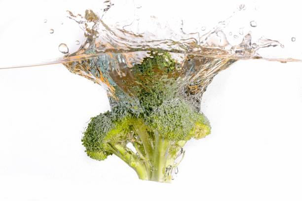 istock Broccoli head dropped in water. 2182142379