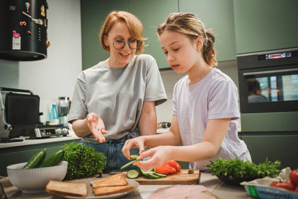 istock mother and daughter cooking in the kitchen 2182146331