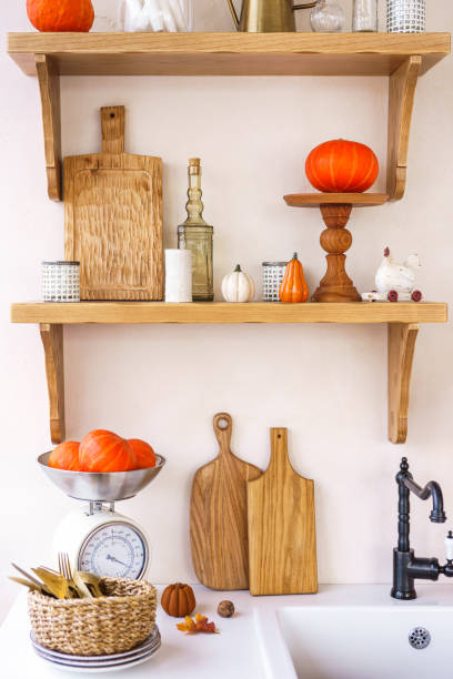 istock Kitchen autumn decor with pumpkins, cutting boards, and vibrant foliage in bright space 2182146553