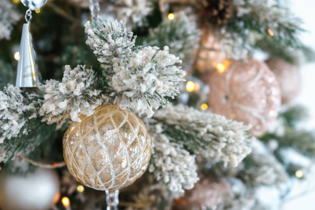 istock Frosted branches of Christmas tree with decorative gold and silver ornaments and shining lights 2182146562