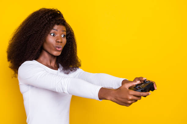 istock Portrait of impressed person arms hold controller pouted lips look empty space isolated on yellow color background 2182147241