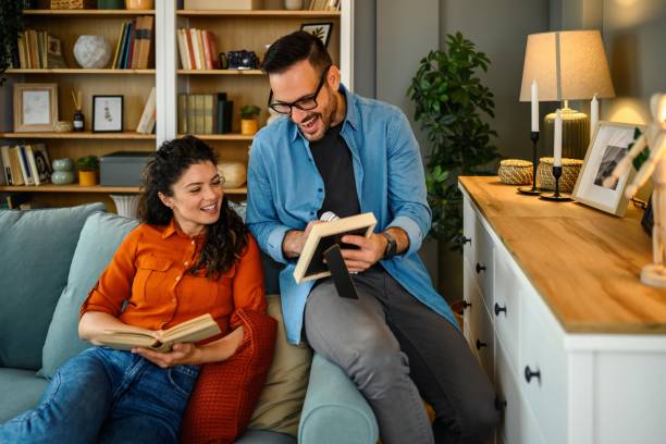istock The man is dusting and his wife is reading a book 2182147345