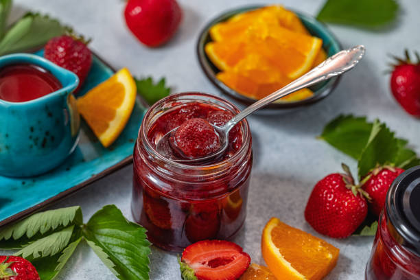 istock Homemade strawberry jam with fresh strawberries and orange slices 2182150310