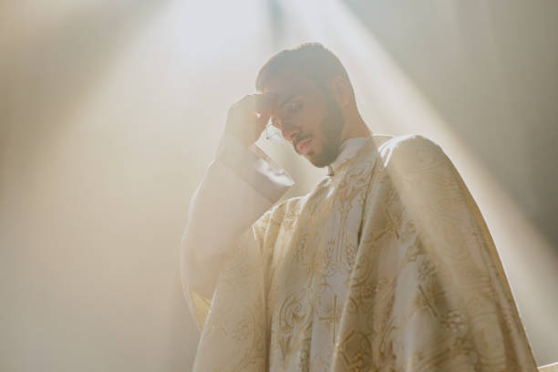 istock Priest in White Robe Crossing Himself 2182150767