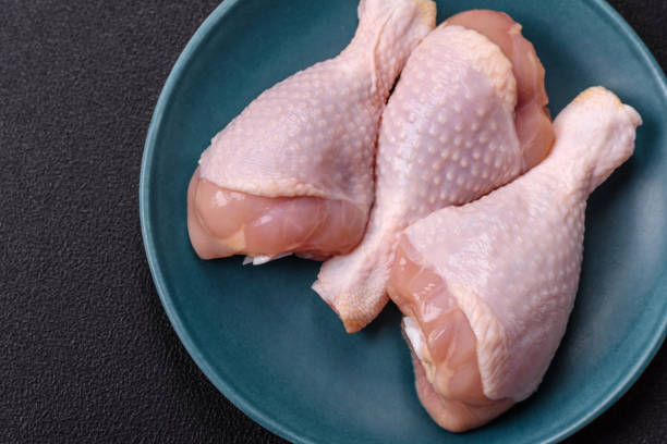 istock Raw chicken legs with salt, spices and herbs 2182152269