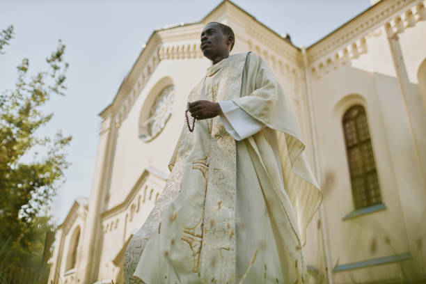 istock Priest with Rosary Walking in Yard 2182153364
