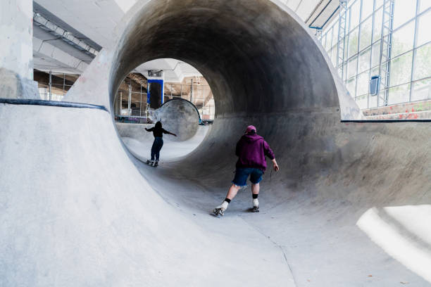 istock Rear view of skaters skating on a skateboard park 2182156480