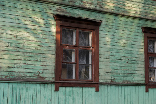 Wooden, rustic, old house with brown windows. High quality photo