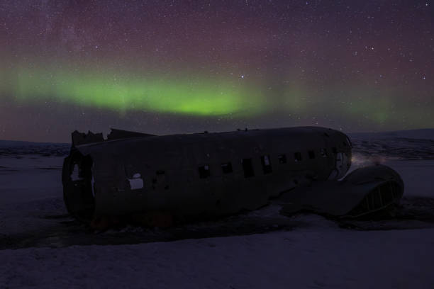 istock Northern lights over plane wreck on the beach in Vik, Iceland 2182156817