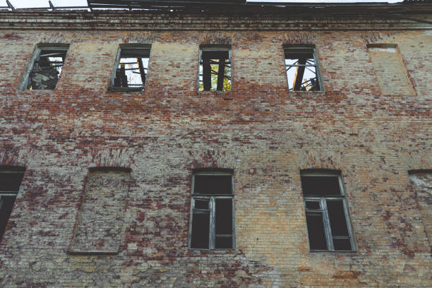 An abandoned building with no windows. An old abandoned, forgotten building, in autumn. High quality photo