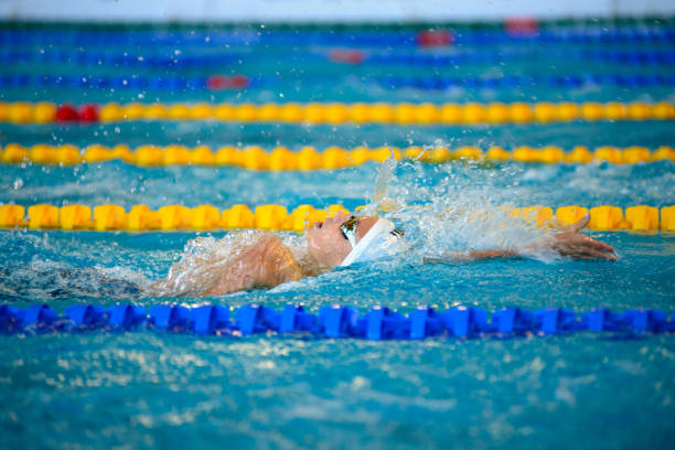 istock Swimmer boy swims backstroke swimming style in the pool 2182156899