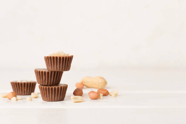 istock Tasty chocolate peanut butter cups on wooden table 2182157073