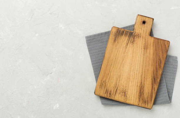 istock Cutting board with napkin on concrete background, top view 2182157470