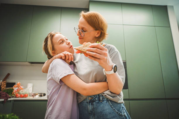 istock mother and daughter cooking in the kitchen 2182159669