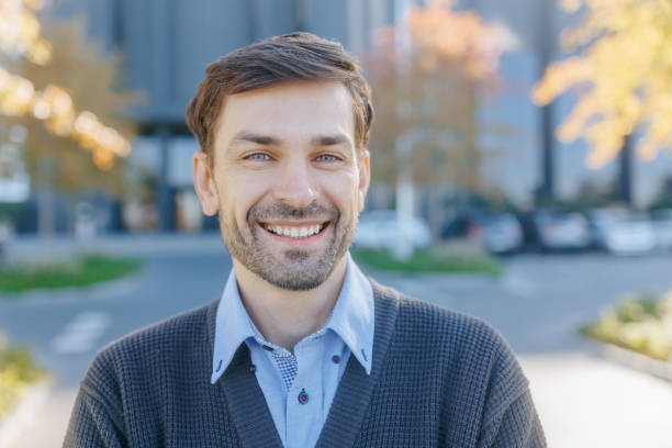 istock Smiling Office Worker in Autumn Setting with Positive Vibe 2182161941