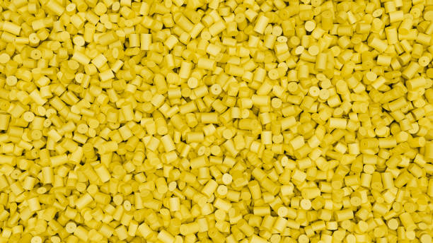 istock Closeup top view of yellow plastic polypropylene granules, masterbatch polymer grain. HDPE or PVC resin pellets. 3d render illustration 2182161971