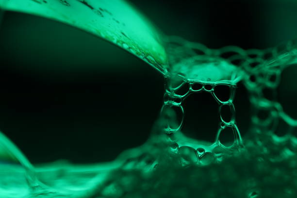Green liquid chain on black background, dark background