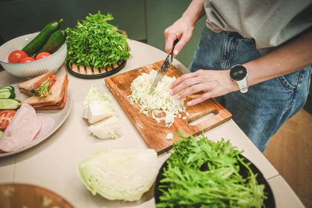 istock woman preparing salad in the kitchen 2182166339