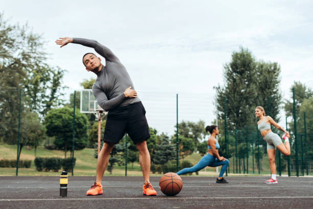 istock Attractive, fit Asian man wearing sportwear warming up, doing exercise outdoors training 2182167833