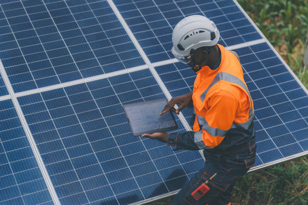 istock Engineer Checking solar panels in agriculture farm land. Engineer examining solar panels at field. Technicians maintenance solar photo voltaic panels  in agriculture farm field. clean energy 2182168749
