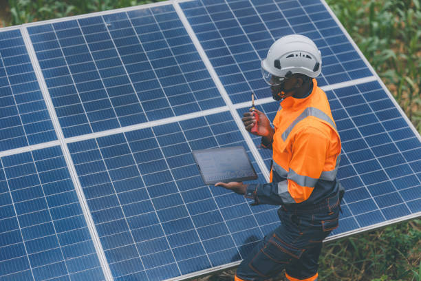 istock Engineer Checking solar panels in agriculture farm land. Engineer examining solar panels at field. Technicians maintenance solar photo voltaic panels  in agriculture farm field. clean energy 2182168750