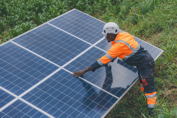 istock Engineer Checking solar panels in agriculture farm land. Engineer examining solar panels at field. Technicians maintenance solar photo voltaic panels  in agriculture farm field. clean energy 2182168788