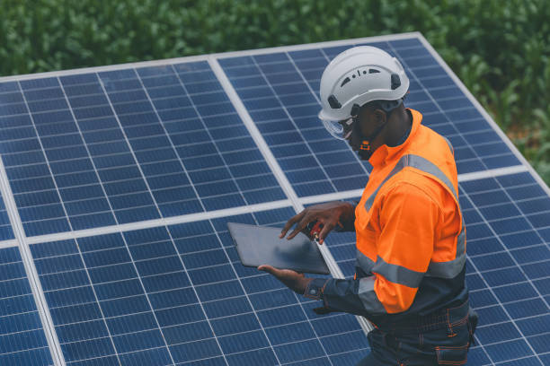 istock Engineer Checking solar panels in agriculture farm land. Engineer examining solar panels at field. Technicians maintenance solar photo voltaic panels  in agriculture farm field. clean energy 2182168843