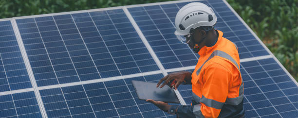 istock Engineer Checking solar panels in agriculture farm land. Engineer examining solar panels at field. Technicians maintenance solar photo voltaic panels  in agriculture farm field. clean energy 2182168846