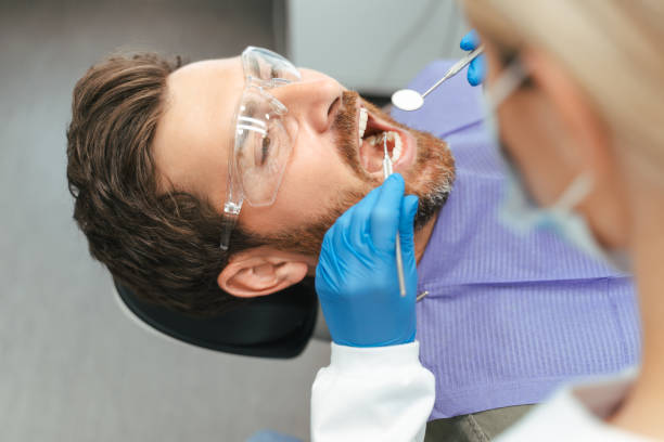 istock Dentist examining patient teeth with dental tools in clinic 2182169496