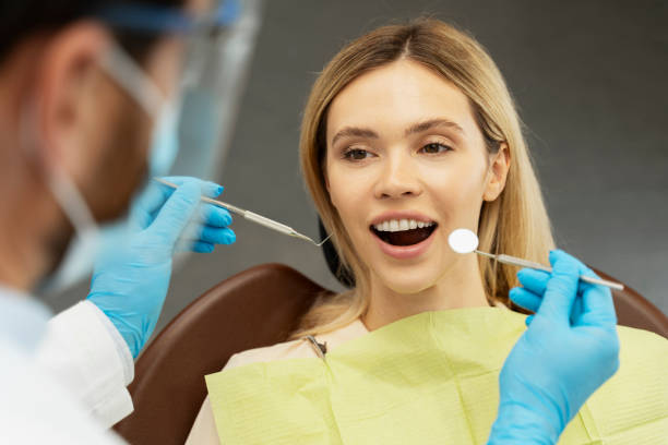 istock Dentist examining patient teeth with dental tools during appointment 2182169532