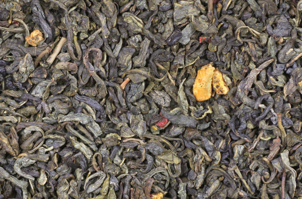 istock black and green tea with pieces of fruit texture background. top view 2182170139