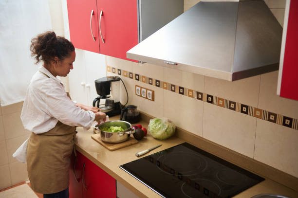 istock Woman preparing fresh salad in modern kitchen interior 2182171403