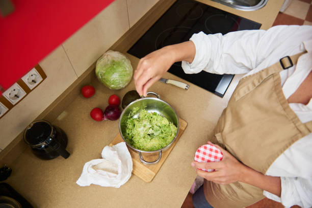 istock Home cook preparing fresh salad in a cozy kitchen 2182171407
