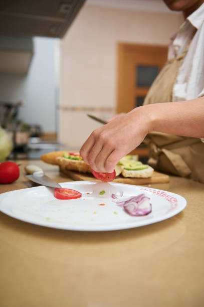 istock Person preparing a homemade sandwich with fresh ingredients 2182171523