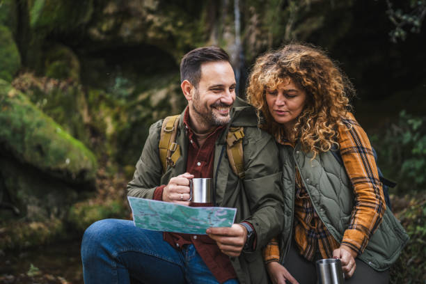 istock couple hiker backpacker hold map and cup find route on map 2182171873