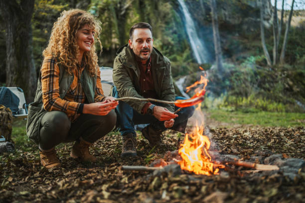 istock hiker couple enjoy on the camp while grill and eat sausage 2182173325