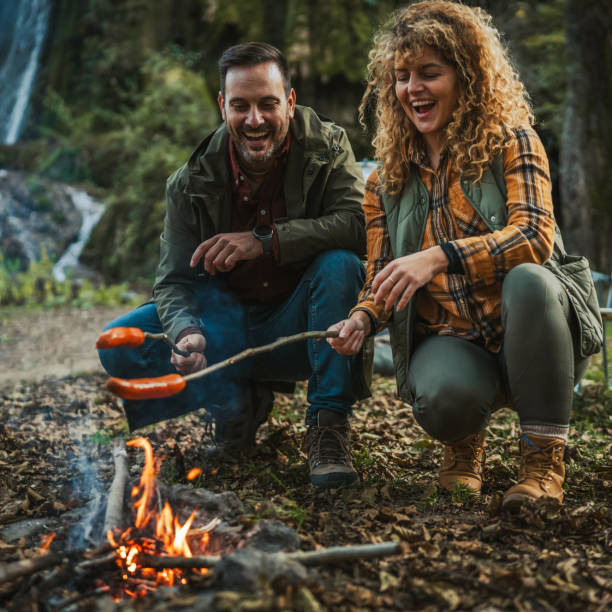 istock hiker couple enjoy on the camp while grill and eat sausage 2182173392