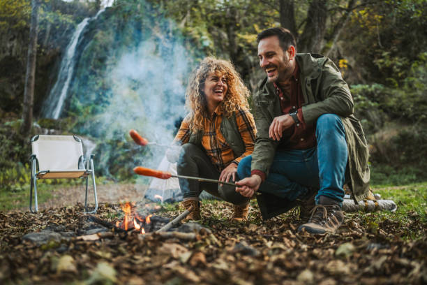 istock hiker couple enjoy on the camp while grill sausage in front tent 2182173715