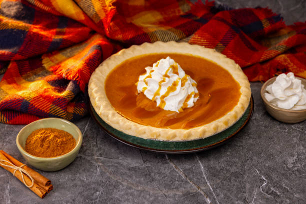 Pumpkin Pie with whipped cream on a gray marble background