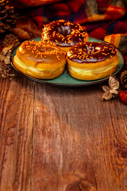 istock Autumn Holiday Donuts on a Retro Wood Background 2182182302