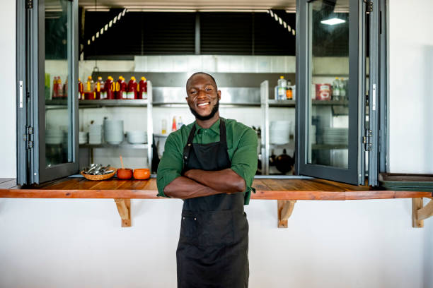 istock Smiling Chef Standing Proudly In Professional Kitchen 2182188150