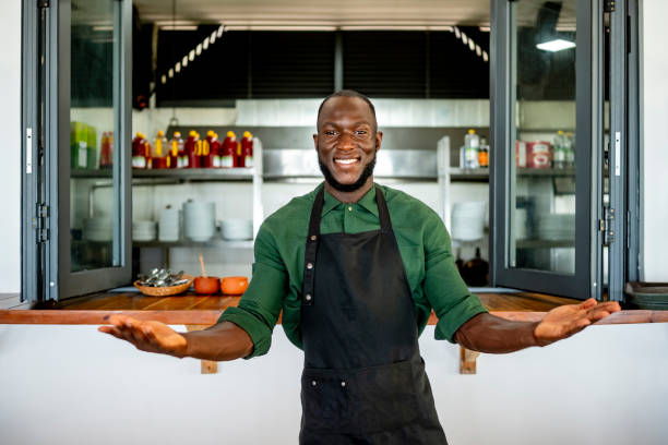 istock Happy Chef Welcoming Customers in Restaurant Kitchen Setting 2182188151