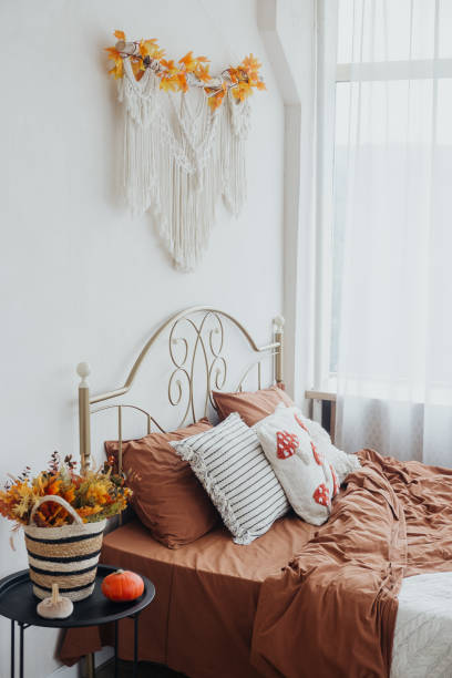 istock Cozy autumn bedroom with decorative elements and warm color tones in bright natural light 2182188971