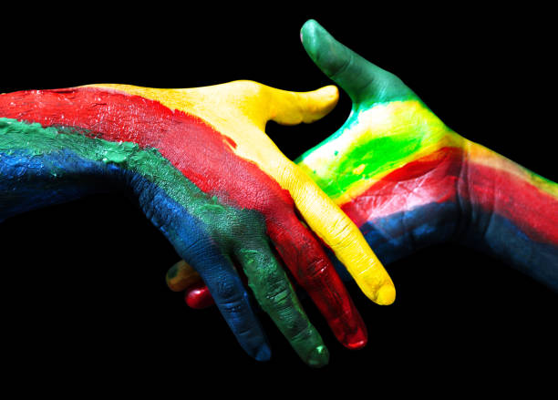 istock Diversity colors handshake with painted hands on black isolated backdrop. Handshake background presenting kindness, diversity, inclusion, union, love and peace 2182203625